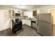 Renovated kitchen featuring stainless steel appliances and granite countertops at 3975 Phylis Pl, Decatur, GA 30035