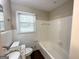 Clean bathroom with bathtub, toilet and granite vanity at 1914 Janet Ln, Decatur, GA 30035