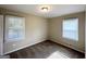 Bedroom with neutral decor, carpet flooring, and two windows at 1914 Janet Ln, Decatur, GA 30035