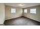 Spacious bedroom with neutral carpeting and multiple windows at 8401 Union Grove Rd, Lithonia, GA 30058