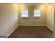 Well-lit bedroom with neutral walls and carpet at 8401 Union Grove Rd, Lithonia, GA 30058