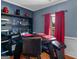 Dark wood dining table with red placemats is set in front of a built-in bar with shelving at 2169 Parador Bnd, Mcdonough, GA 30253