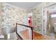 Upstairs hallway showcasing patterned wallpaper and hardwood floors at 4618 Shallowford Rd, Roswell, GA 30075