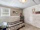 Small bedroom with a leopard print bedspread and white brick accent wall at 2110 Mcgarity Rd, Mcdonough, GA 30252