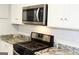 Modern gas range and microwave in a stylish kitchen setting at 1407 Vesta Ave, East Point, GA 30344