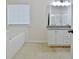 Bathroom boasts double vanity, granite countertop, and shower at 33 Ball St, Moreland, GA 30259
