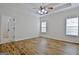 Main bedroom with high ceiling, wood floor, and two windows at 33 Ball St, Moreland, GA 30259