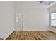 Well-lit bedroom with wood-look floors and access to bathroom at 33 Ball St, Moreland, GA 30259