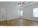 Spacious bedroom with wood-look floors and ceiling fan at 33 Ball St, Moreland, GA 30259
