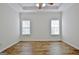 Main bedroom with high ceiling, wood floor and two windows at 33 Ball St, Moreland, GA 30259