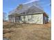 Green house exterior with screened porch at 33 Ball St, Moreland, GA 30259