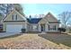 Two-story house with green siding, a white garage door, and a well-maintained lawn at 33 Ball St, Moreland, GA 30259