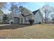 Green house exterior showcasing a side view of the home and surrounding trees at 33 Ball St, Moreland, GA 30259