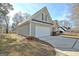 White garage door with landscaping and a concrete driveway at 33 Ball St, Moreland, GA 30259