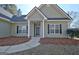 Front entrance with a dark brown door and landscaping at 33 Ball St, Moreland, GA 30259