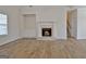 Living room with a fireplace, built-in shelving, and hardwood floors at 33 Ball St, Moreland, GA 30259