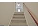 Carpeted staircase with wooden railing at 33 Ball St, Moreland, GA 30259