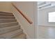 Carpeted staircase leading to upper level at 33 Ball St, Moreland, GA 30259