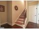 Staircase with carpeted steps and wrought iron railing at 900 Eskew Rd, Mcdonough, GA 30252