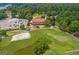 Aerial view of golf course clubhouse with parking lot at 127 Darwish Dr, Mcdonough, GA 30252