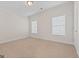 Simple bedroom with neutral carpet and windows at 127 Darwish Dr, Mcdonough, GA 30252