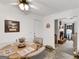 Bright dining area with wood table and seating for four, adjacent to living room with fireplace at 220 Melrose Way, Mcdonough, GA 30252