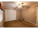 Well lit bedroom with carpet flooring and large closet at 371 Branham Cir, Social Circle, GA 30025