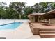 Large in-ground pool with a spacious wooden deck and a privacy fence at 371 Branham Cir, Social Circle, GA 30025