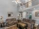 Two-story living room with vaulted ceiling, fireplace and comfy seating at 1302 Eddie Craig Ct, Mcdonough, GA 30252