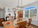 Dining room with hardwood floors, wooden table, and hutch at 109 Faversham Dr, Mcdonough, GA 30252