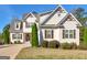 Two-story house with beige siding, brown shutters, and a landscaped lawn at 109 Faversham Dr, Mcdonough, GA 30252