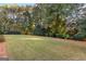 Landscaped backyard with lush lawn, providing ample outdoor space at 248 Montrose Dr, Mcdonough, GA 30253