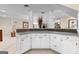 Basement bar with white cabinets and a granite countertop at 248 Montrose Dr, Mcdonough, GA 30253