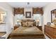 Elegant bedroom with striped bedding, and a ceiling fan at 248 Montrose Dr, Mcdonough, GA 30253