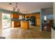 Kitchen with island, wood cabinets and tile floor at 218 Groveland Dr, Peachtree City, GA 30269