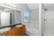 Bathroom boasts a double vanity, jetted tub, and shower at 30 Capeton Ct, Covington, GA 30016