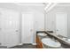 Double vanity bathroom with granite countertops and large mirror at 30 Capeton Ct, Covington, GA 30016