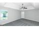 Bedroom with window, ceiling fan, and gray carpet at 30 Capeton Ct, Covington, GA 30016