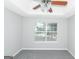 Spacious bedroom with ceiling fan and window at 30 Capeton Ct, Covington, GA 30016