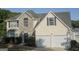 Two-story house with stone accents and a two-car garage at 30 Capeton Ct, Covington, GA 30016
