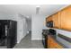 Kitchen boasts black appliances and wood cabinets at 30 Capeton Ct, Covington, GA 30016