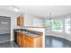 Kitchen with wood cabinets, black appliances, and island at 30 Capeton Ct, Covington, GA 30016