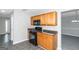 Kitchen with wood cabinets and black appliances at 30 Capeton Ct, Covington, GA 30016