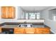 Modern kitchen features wood cabinets, black appliances, and a breakfast bar at 30 Capeton Ct, Covington, GA 30016