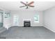 Spacious living room featuring a fireplace and grey carpeting at 30 Capeton Ct, Covington, GA 30016