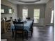 Bright dining room featuring a table with seating for six and hardwood floors at 976 Buckhorn Bnd, Locust Grove, GA 30248