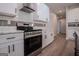 Bright kitchen featuring white cabinets, stainless steel range, and subway tile backsplash at 4694 E Glen Ridge Cir, Winston, GA 30187