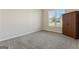 Bright bedroom with neutral walls, gray carpeting, and a built-in wardrobe at 1611 Stillriver Run Dr, Mcdonough, GA 30252