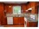 Kitchen with wood cabinets, granite countertops, and modern appliances at 1966 Woodlot Trl, Lithonia, GA 30058