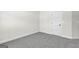 Empty basement room with grey carpet and white door at 278 Deer Creek Run # 3-12, Moreland, GA 30259